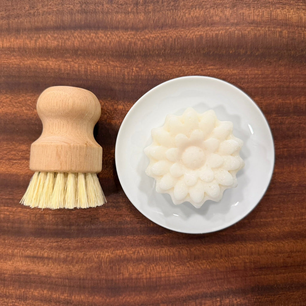 Bar of dish soap in small dish with scrub brush