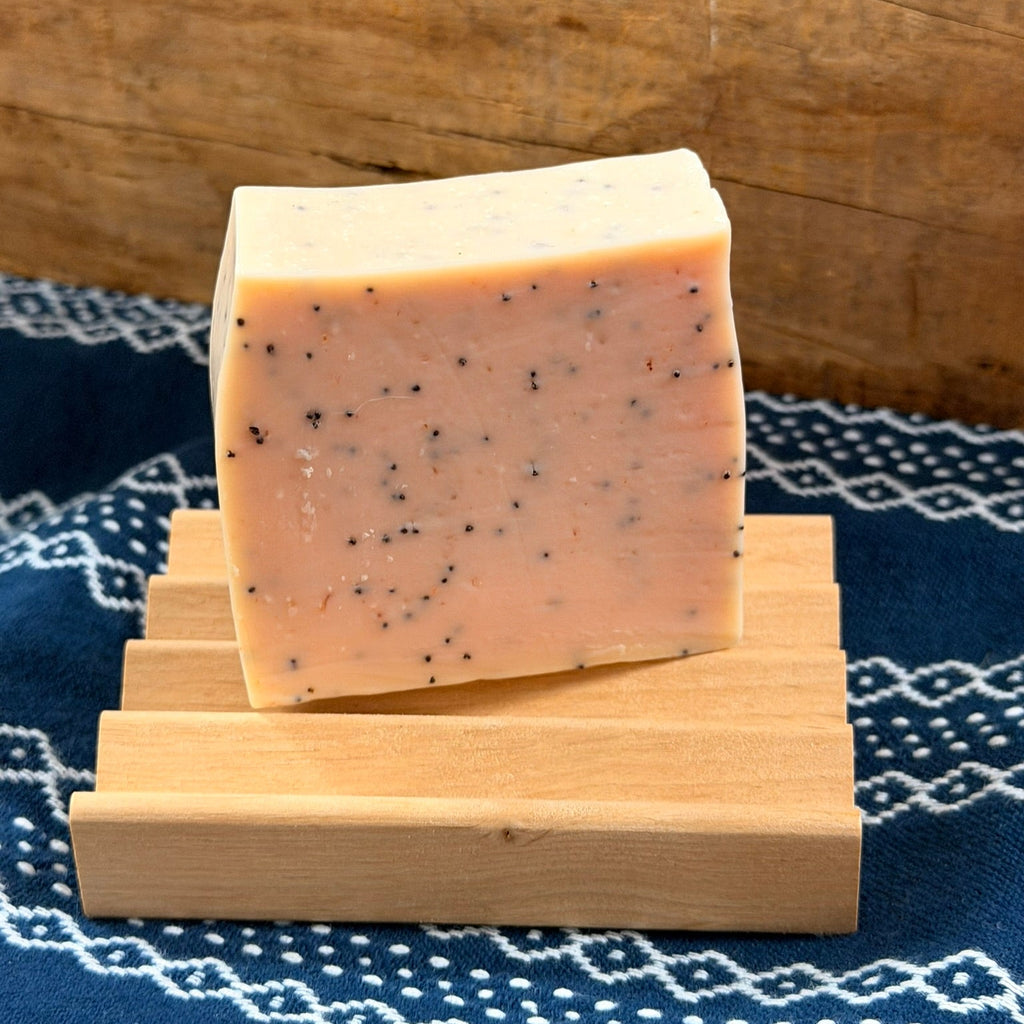 Wooden soap dish with bar of soap on it