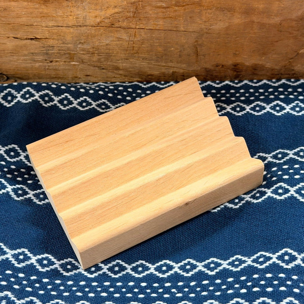 Wooden soap dish on blue cloth
