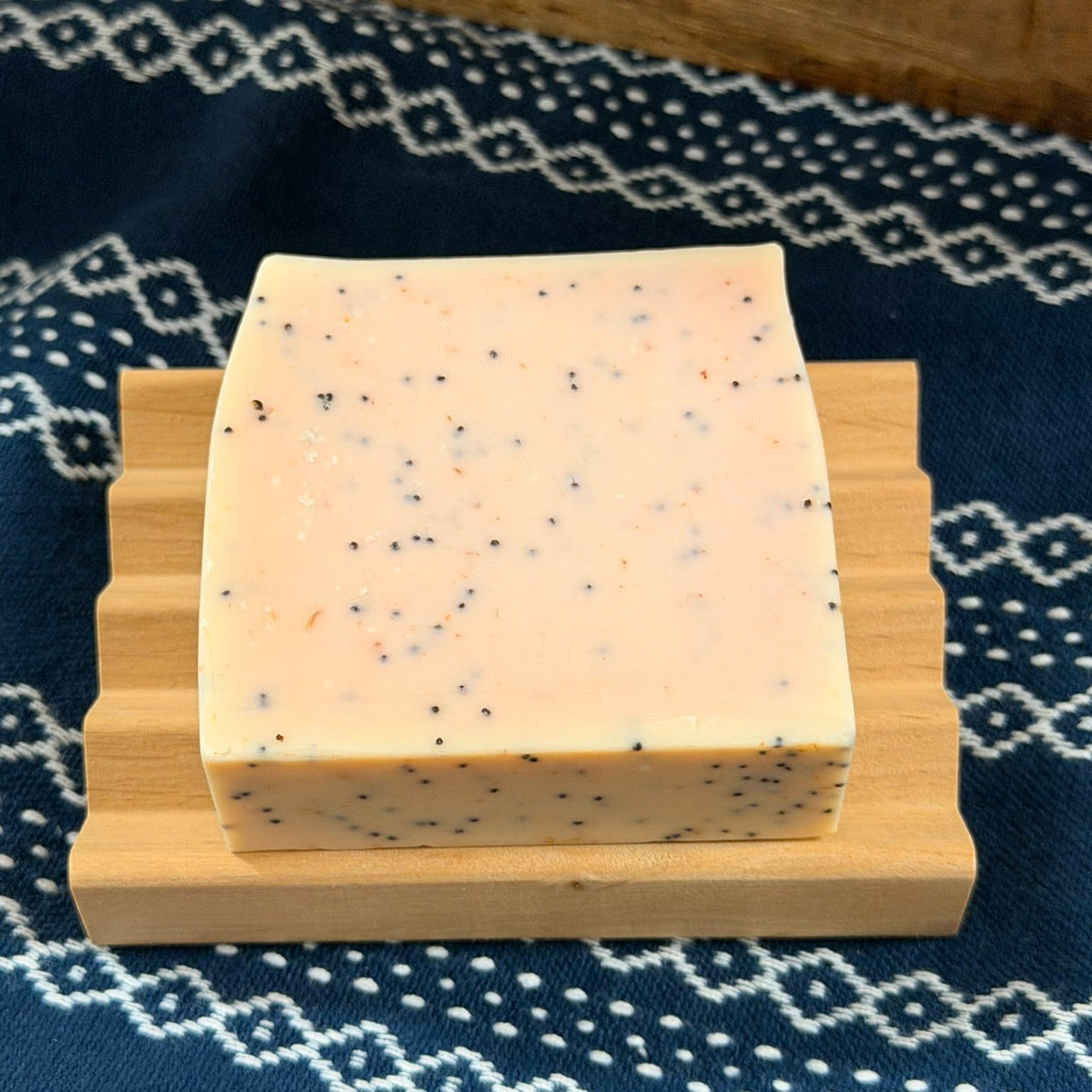 Wooden soap dish with bar of soap on it